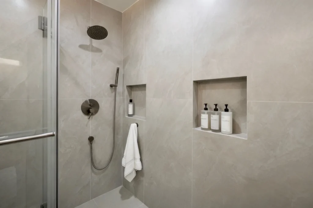 ADU shower detail with wall niche and glass enclosure