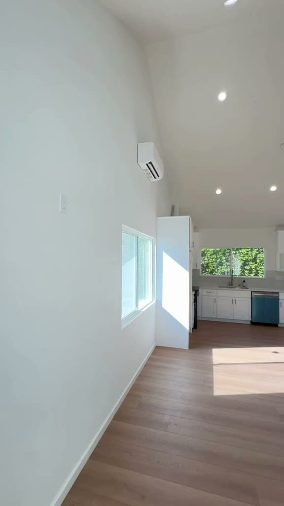 Vaulted high ceiling over the open living and kitchen area of a 700 sq ft ADU in Pasadena with recessed lights and clerestory window
